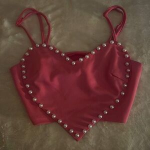 Selling a pink heart shaped top with cute pearls along the side!